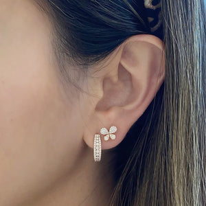 Female model wearing diamond triple row huggie earrings - 18K gold weighing 2.66 grams  - 84 round diamonds totaling 0.52 carats