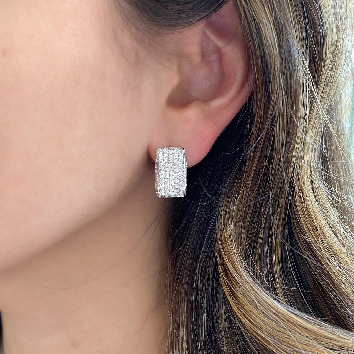 Female Model Wearing Diamond Chunky Huggie Earrings - 18K gold weighing 9.73 grams  - 126 round diamonds totaling 2.22 carats