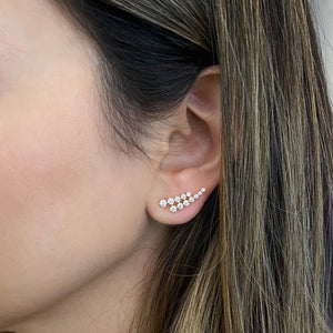 female model wearing diamond double row crawler earrings - 14K gold weighing 2.31 grams - 24 round diamonds totaling 0.92 carats