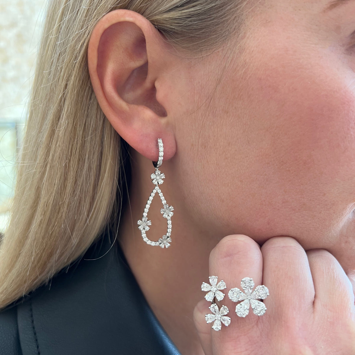 Female model wearing Diamond Triple Flower Open Ring - 18K gold weighing 6.11 grams - 15 pear-shaped diamonds weighing 1.92 carats - 15 marquise-shaped diamonds weighing 0.47 carats - 5 princess-cut diamonds weighing 0.13 carats - 2 round diamonds weighing 0.04 carats