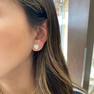 Female Model Wearing Round and Baguette Diamond Heart Stud Earrings - 14K gold weighing 2.55 grams  - 24 round diamonds weighing 0.39 carats  - 10 slim baguettes weighing 0.54 carats