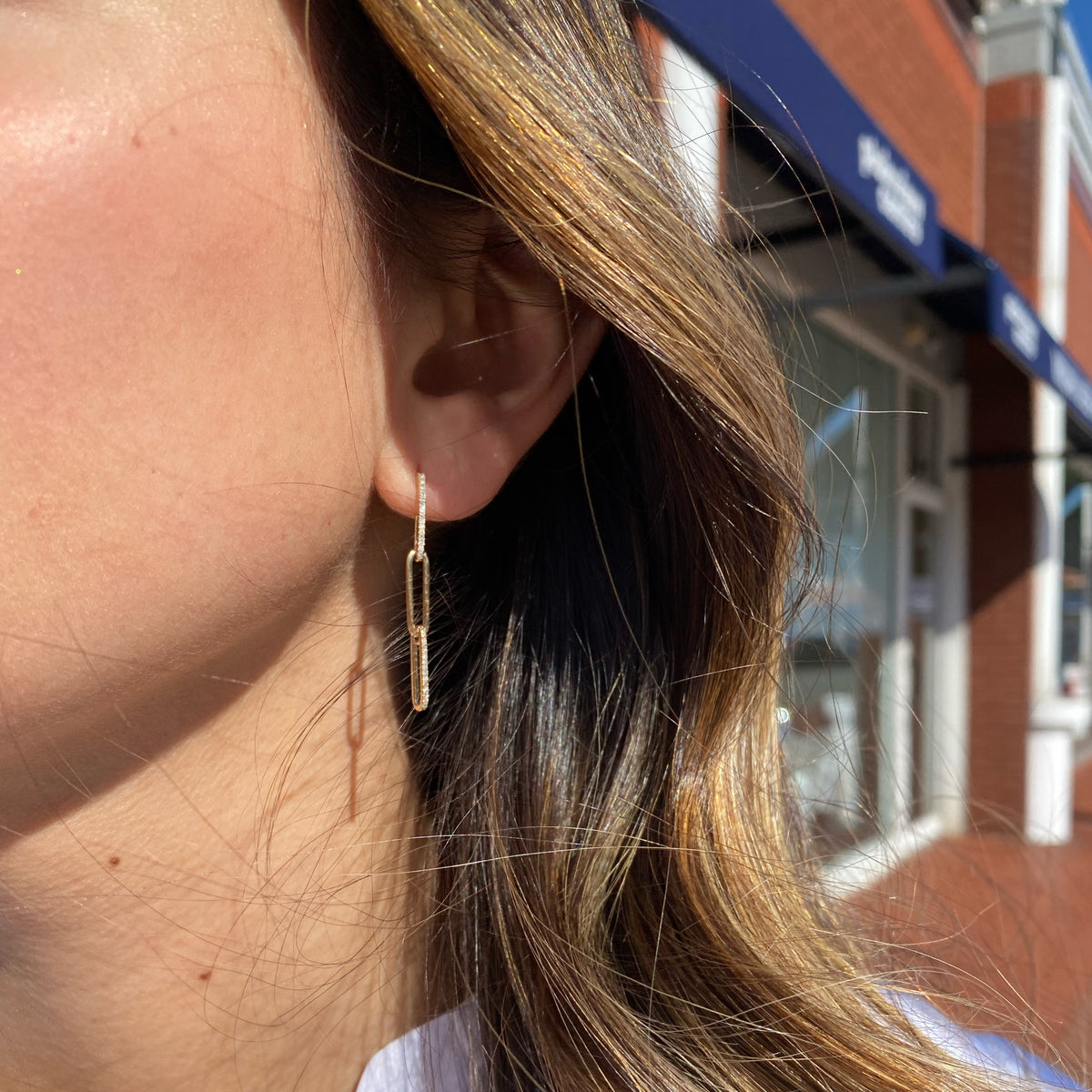 Female Model Wearing Diamond Paperclip Chain Earrings - 14K gold weighing 2.64 grams  - 62 round diamonds weighing 0.18 carats