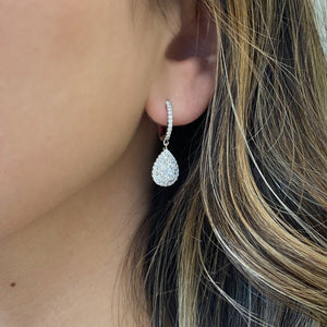 Female Model Wearing Diamond Cluster Teardrop Dangle Earrings - 18K gold weighing 4.70 grams  - 90 round diamonds weighing 1.42 carats