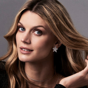 female model wearing diamond large star stud earrings - 14K gold weighing 5.92 grams  - 142 round diamonds totaling 1.95 carats