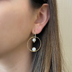 Female model wearing Pearl & Diamond Hoop Earrings  - 14K gold weighing 4.88 grams  - 44 round diamonds totaling 0.16 carats  - 4 pearls