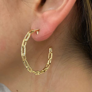 Female model wearing Diamond chain open hoop earrings - 14K gold weighing 9.51 grams  - 98 round diamonds totaling 0.43 carats