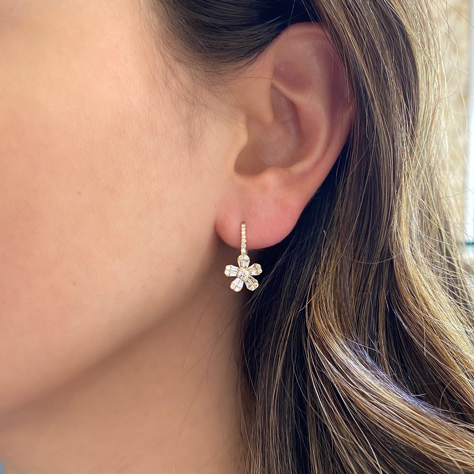 Diamond Daisy Lever-Back Earrings   -14K gold weighing 2.36 grams  -20 straight baguettes totaling 0.45 carats  -36 round diamonds totaling 0.43 carats