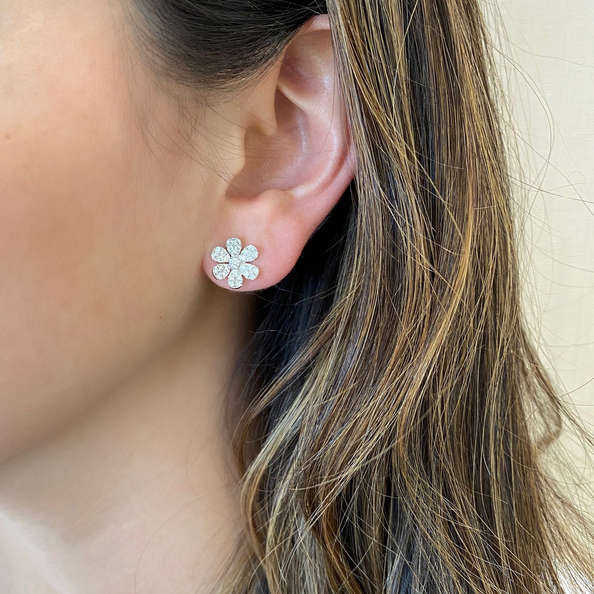 Female model wearing Large Diamond Flower Stud Earrings - 14K gold weighing 2.53 grams - 62 round diamonds totaling 0.74 carats