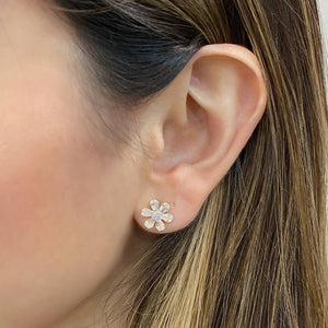 female model wearing Round & Baguette Diamond medium flower stud earrings - 14K gold weighing 3.21 grams - 24 slim baguettes totaling 0.49 carats - 26 round diamonds totaling 0.34 carats