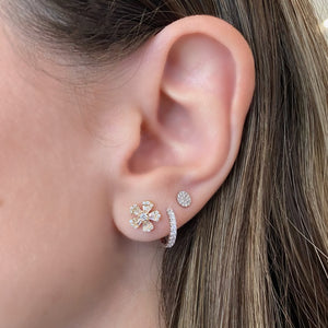female model wearing round & baguette diamond mini flower stud earrings - 14K gold weighing 2.12 grams  - 20 slim baguettes totaling 0.32 carats  - 32 round diamonds totaling 0.24 carats