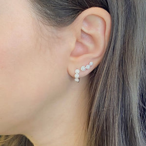 Female model wearing Diamond halo huggie earrings- 14K gold  - 0.37 cts round diamonds