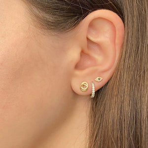 Female model wearing Diamond Interlocking Links Stud Earrings - 14K gold - 26 round diamonds totaling 0.09 carats