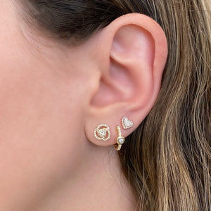 Female Model Wearing Bezel-Set Diamond Huggie Earrings - 14K gold weighing 2.07 grams  - 16 round diamonds totaling 0.16 carats