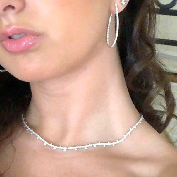 Female model wearing Oval Inside/Out Diamond  Hoop Earrings -18k gold weighing 8.73 grams -104 round diamonds weighing 1.58 carats