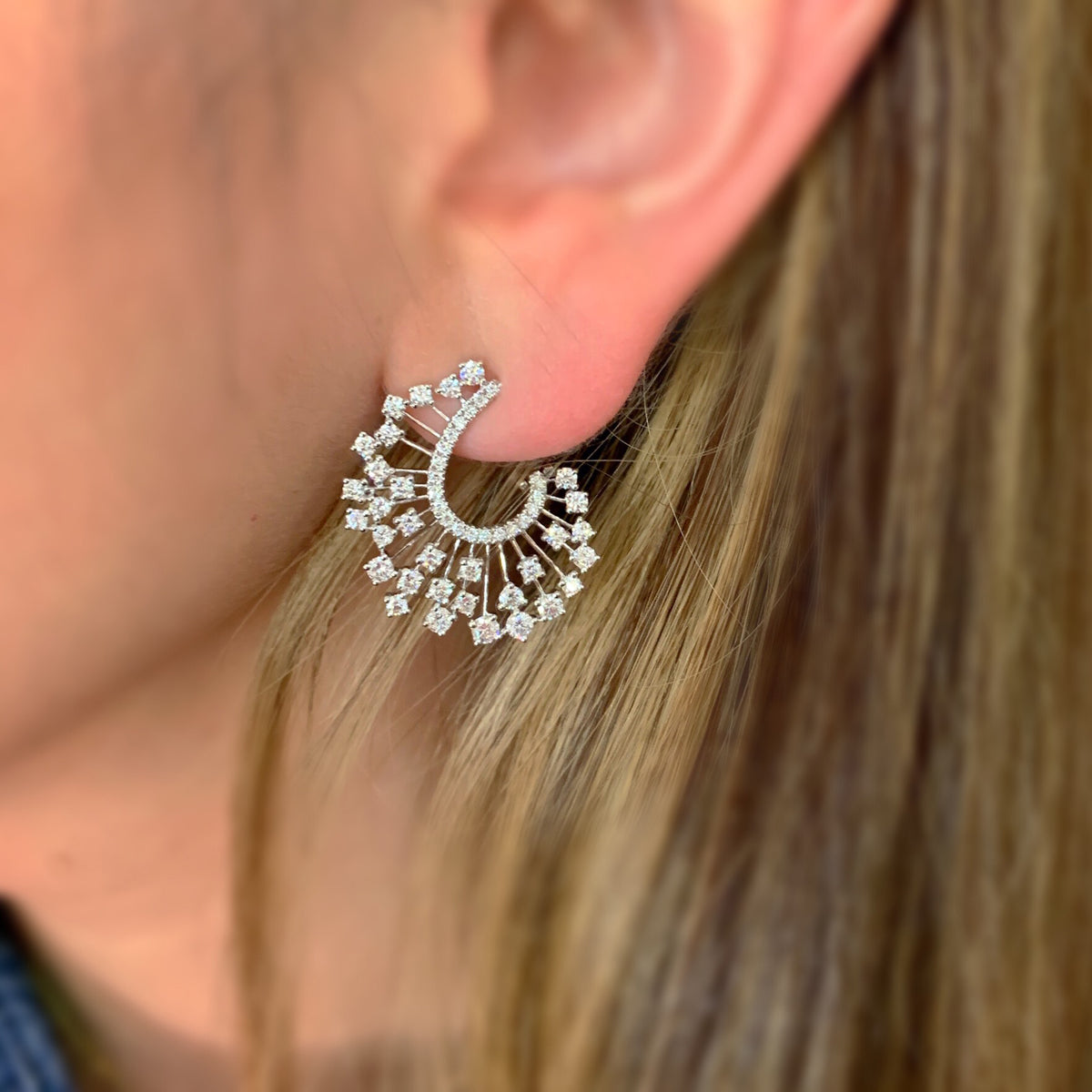 Female Model Wearing Diamond Starburst Earrings  -18K gold weighing 7.51 grams  -104 round diamonds totaling 2.04 carats