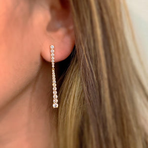 Female model wearing Shared Prong-Set Diamond Dangle Earrings -14K gold weighing 2.6 grams -36 round diamonds totaling 2.01 carats