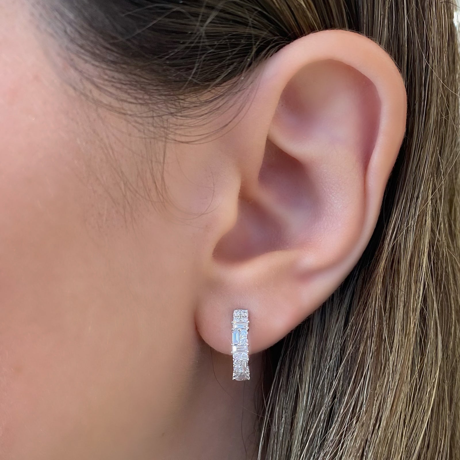 Mixed Cut Diamond Huggie Earrings - 18K gold weighing 3.19 grams - 28 round diamonds totaling 0.33 carats - 10 slim baguettes totaling 0.28 carats.