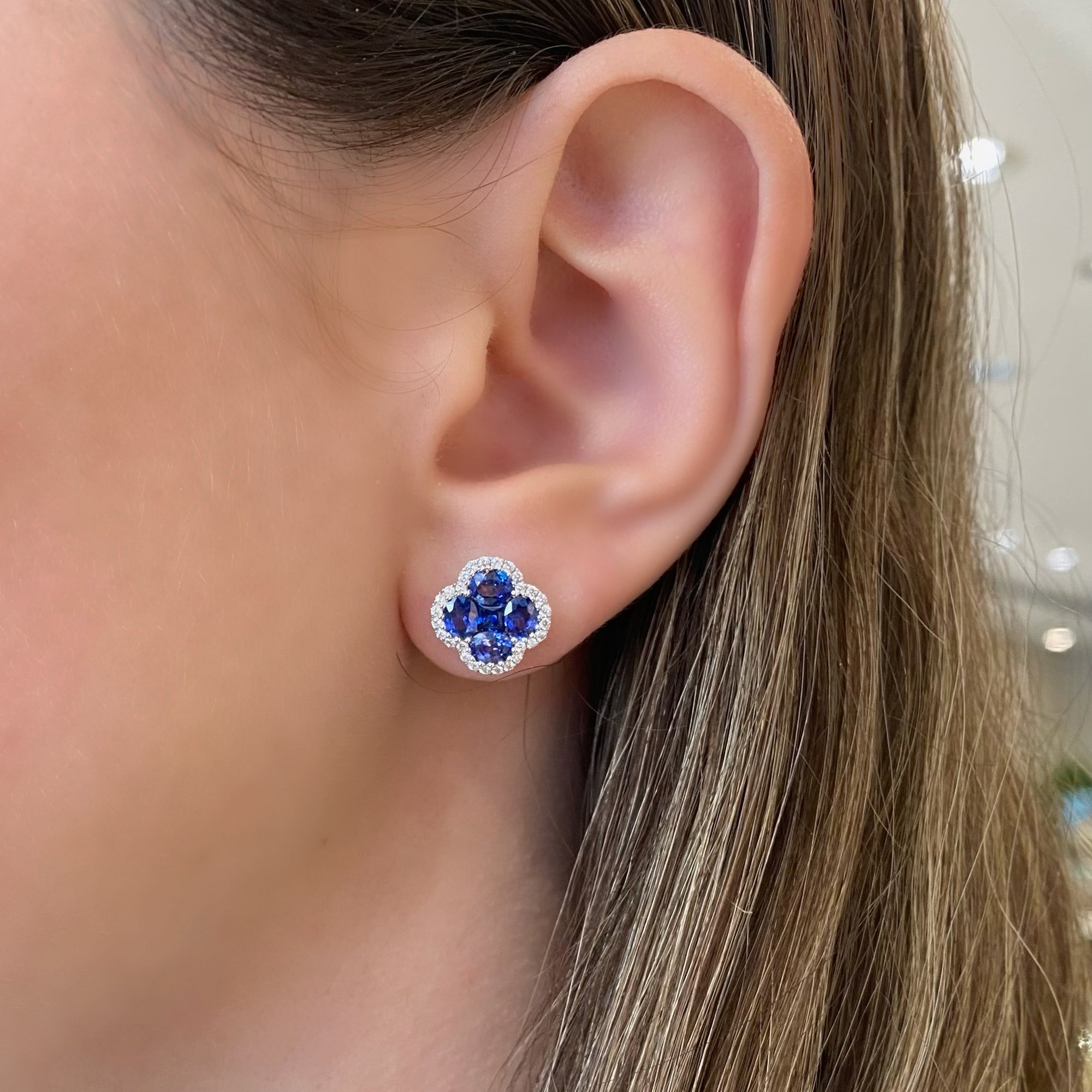 sapphire & diamond flower stud earrings - 18K gold weighing 3.37 grams  - 8 oval-shaped sapphires totaling 2.40 carats  - 2 princess-cut sapphires totaling 0.34 carats  - 56 round diamonds totaling 0.28 carats