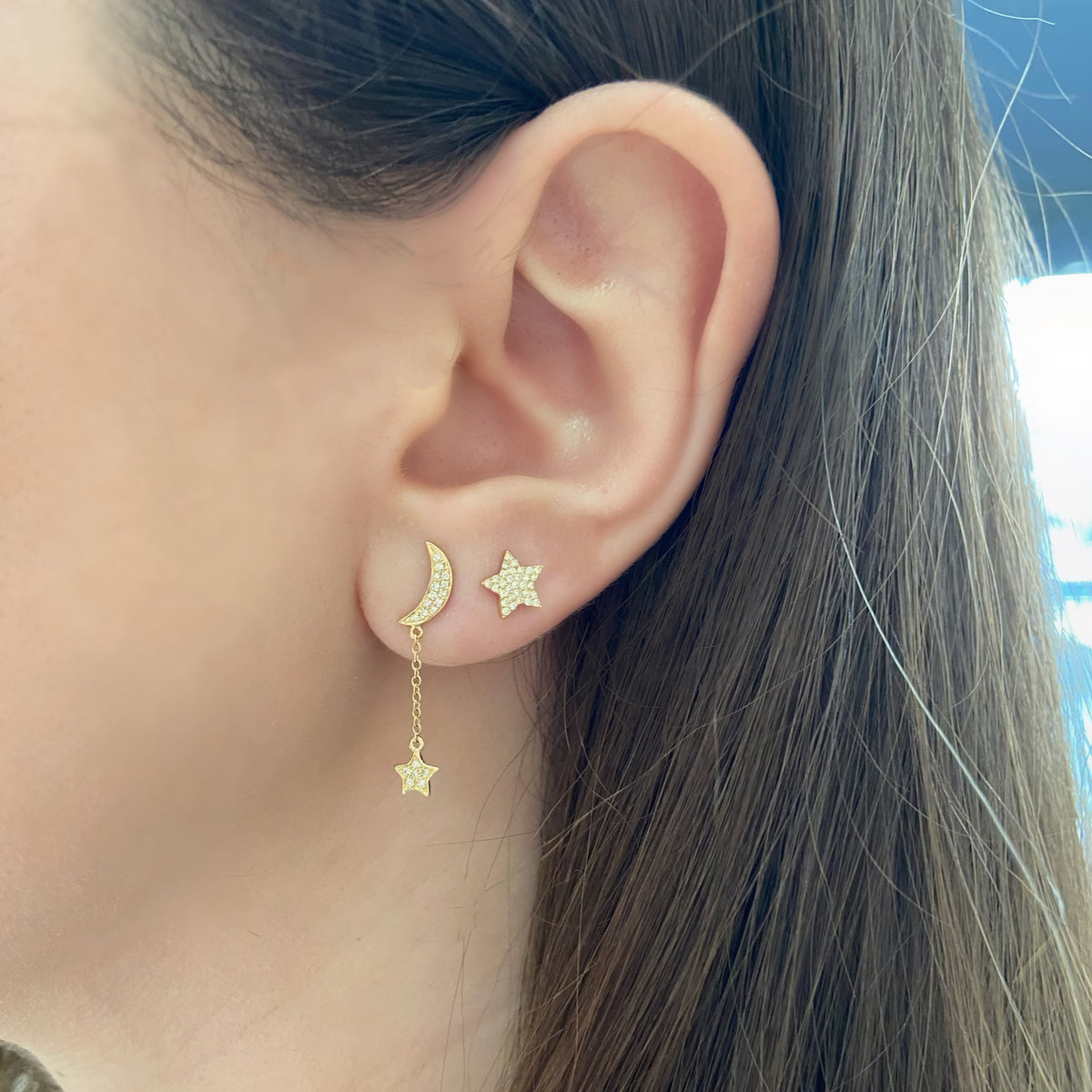 Female model wearing Diamond Crescent Moon & Star Dangle Earrings - 14K gold weighing 1.51 grams - 38 round diamonds totaling 0.10 carats