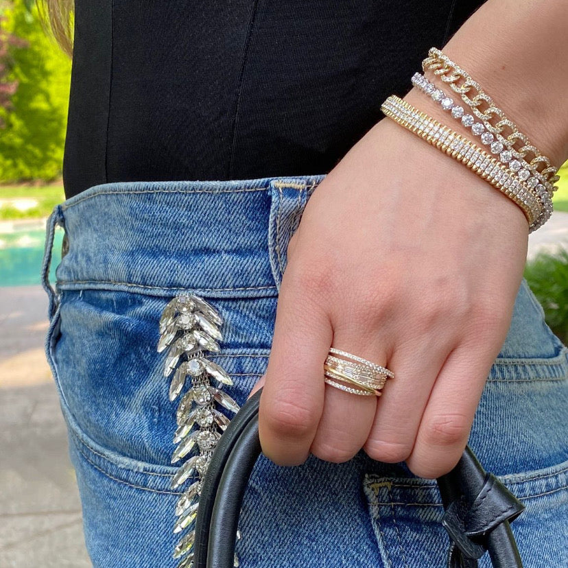 Diamond Baguette Crossover Ring   -14K gold weighing 5.56 grams  -113 round diamonds totaling 0.86 carats  -14 straight baguettes totaling 0.90 carats