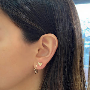 Female model wearing Diamond Small Star Hoop Earrings - 14K yellow gold weighing 1.79 grams  - 42 round diamonds totaling 0.12 carats