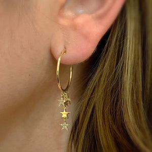 Female Model Wearing Diamond Star Drop Push-Back Hoop Earrings -14K gold weighing 3.64 grams -54 round diamonds totaling 0.12 carats
