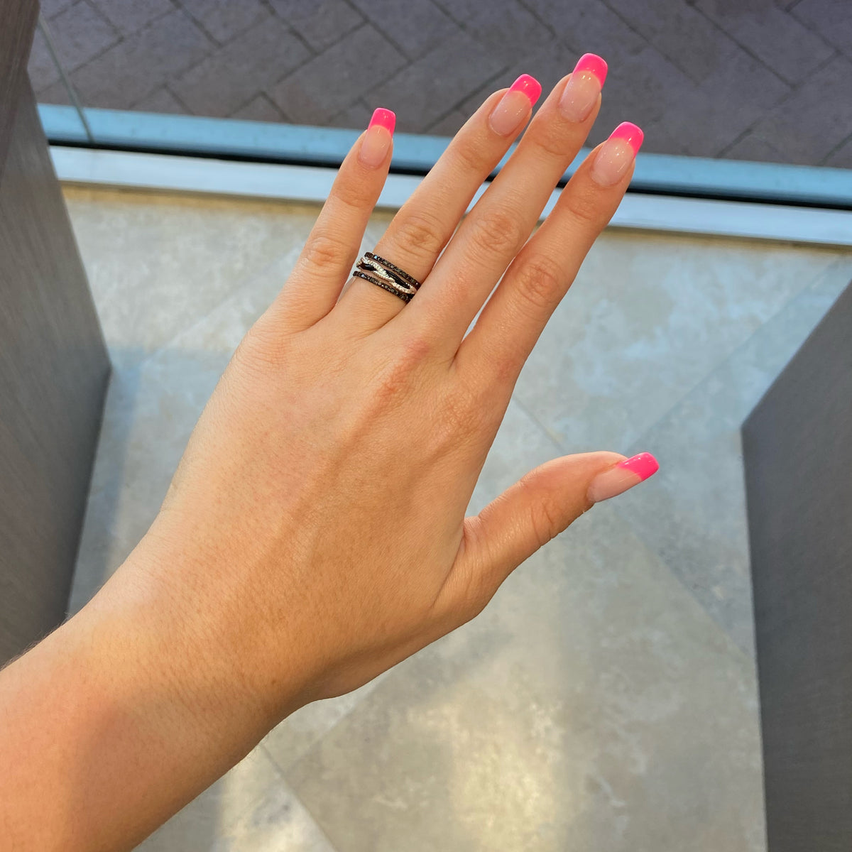 Female Model Wearing Black Diamond Eternity Band  -30 round black diamonds totaling 0.35 carats.  -14kt gold with black rhodium weighting 1.19 grams.