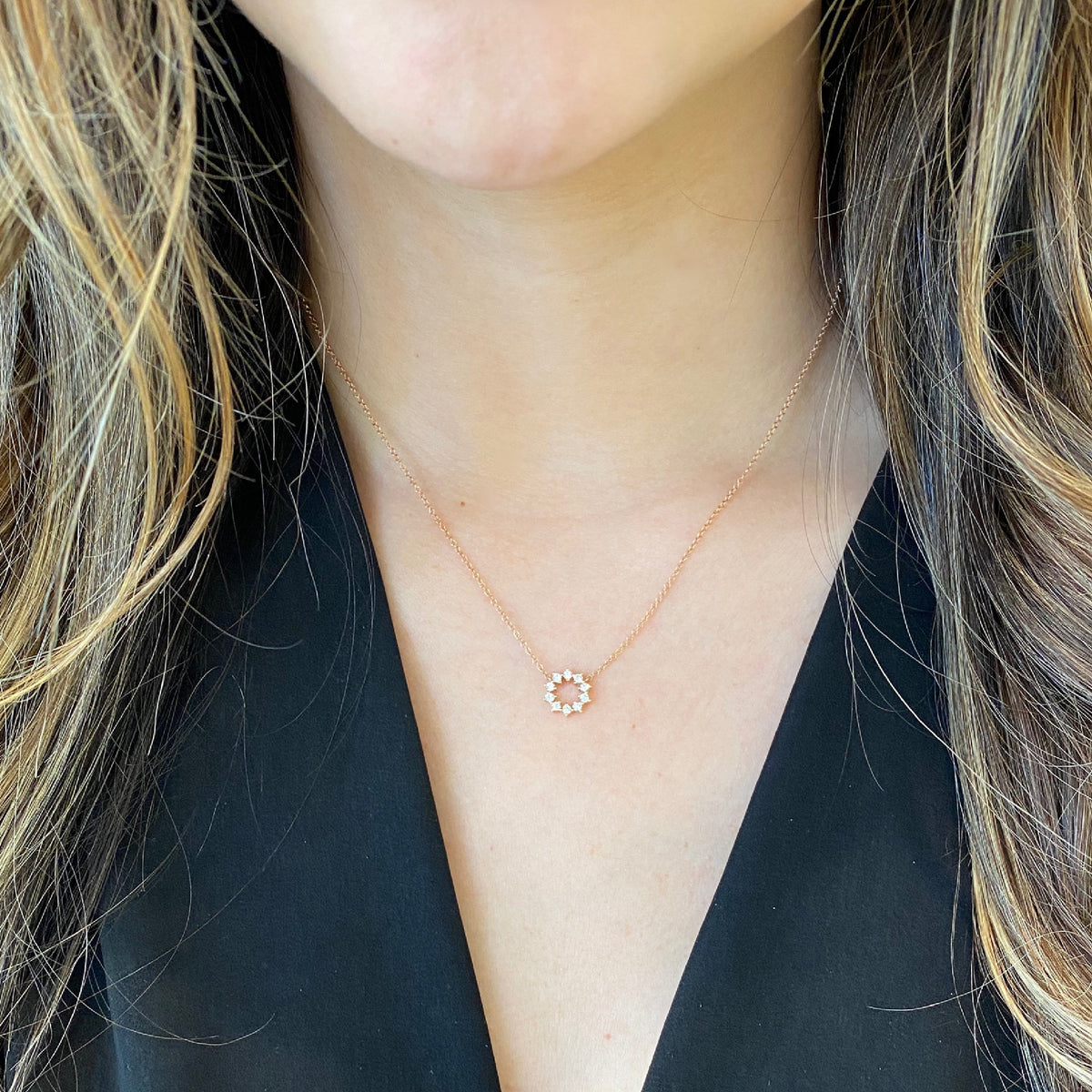 Female Model Wearing Diamond Small Sunburst Necklace  - 14K gold weighting 1.70 grams.  - 10 round diamond totaling .22 carat weight