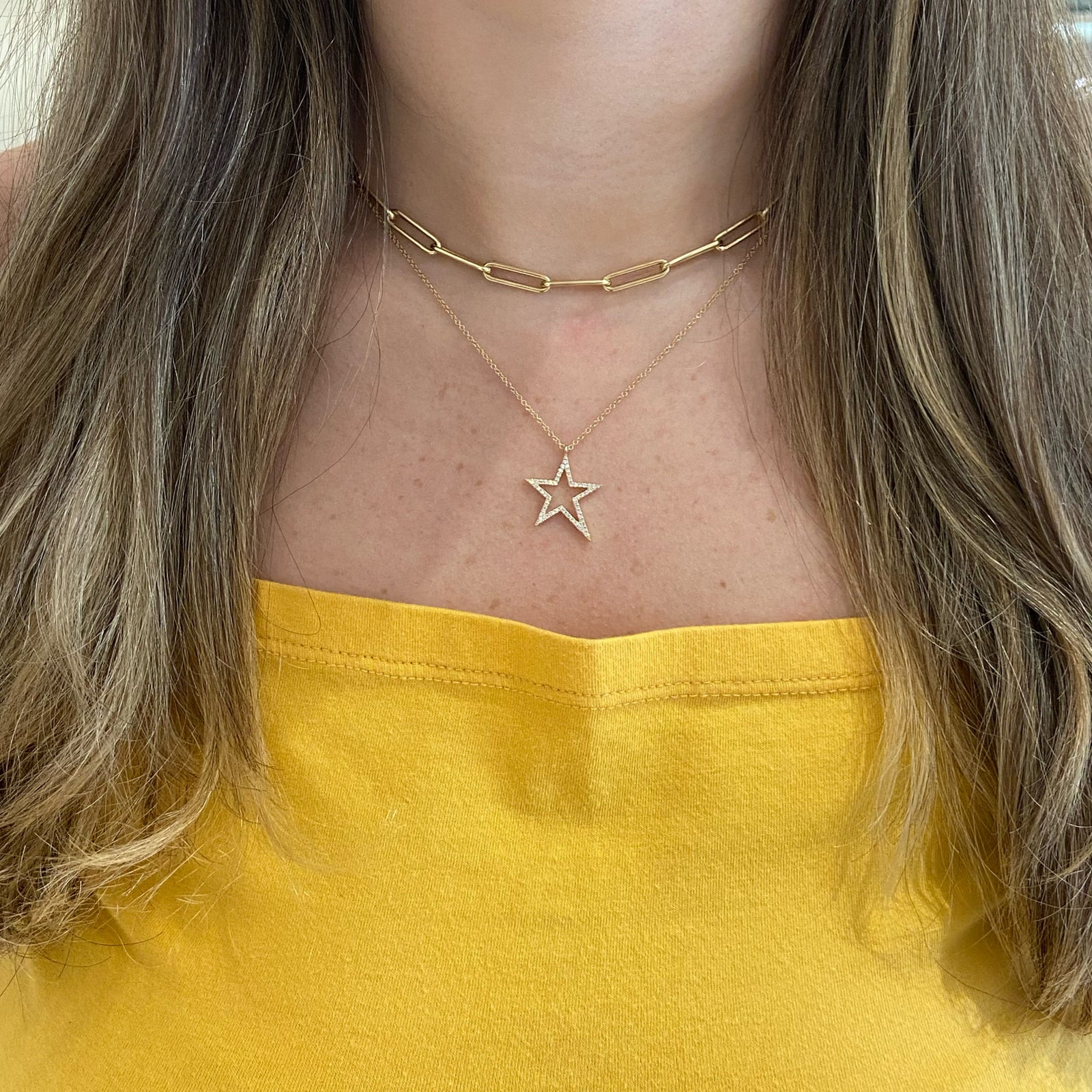 Diamond Asymmetrical Star Pendant Necklace - 14K yellow gold weighing 2.23 grams. - 59 round diamonds 0.17 carats.
