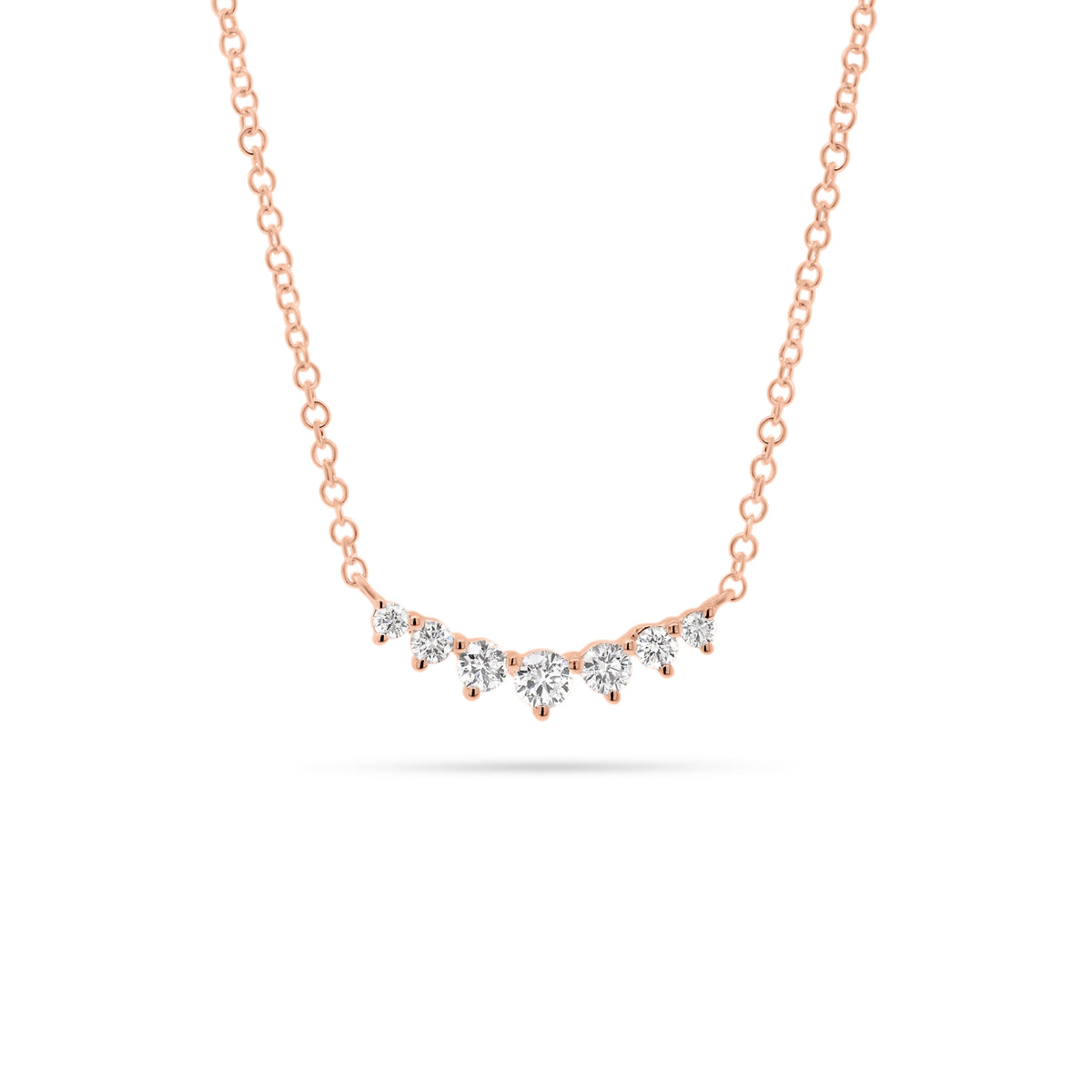 Graduated Diamond Bar Pendant  - 14K gold weighing 1.58 grams  - 7 round diamonds totaling 0.20 carats
