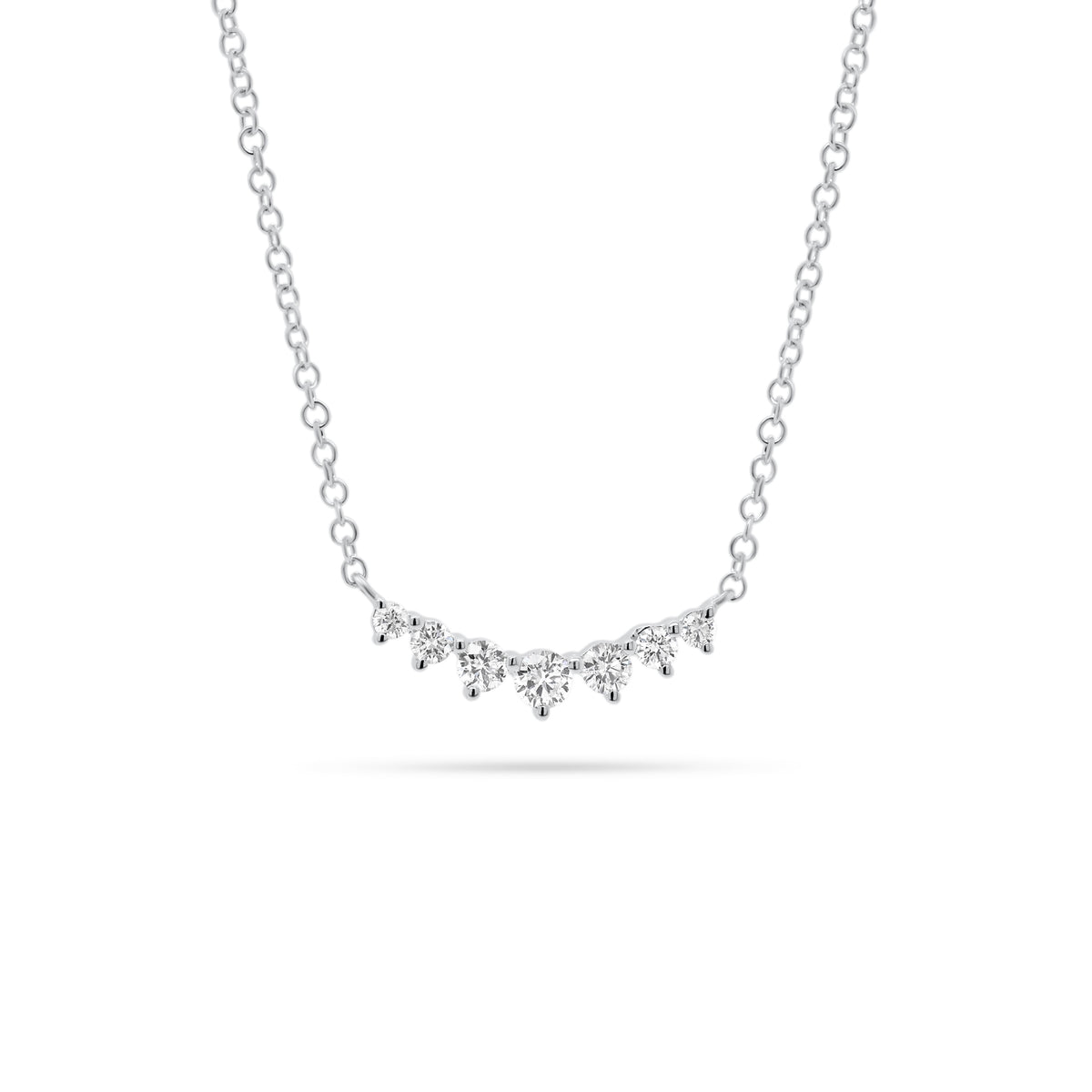 Graduated Diamond Bar Pendant  - 14K gold weighing 1.58 grams  - 7 round diamonds totaling 0.20 carats