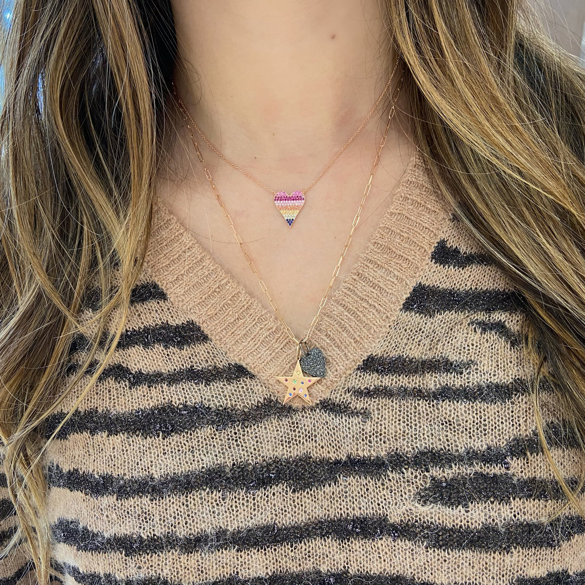 Female model wearing Black Diamond Heart Pendant - 14K gold weighing 1.83 grams - 49 black round diamonds totaling 0.50 carats