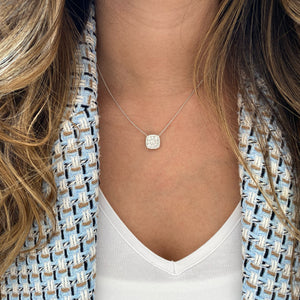 Female Model Wearing Diamond Cushion Pendant Necklace   - 18k gold weighting 3.75 grams.   - 35 round diamonds totaling 1.03 carats.