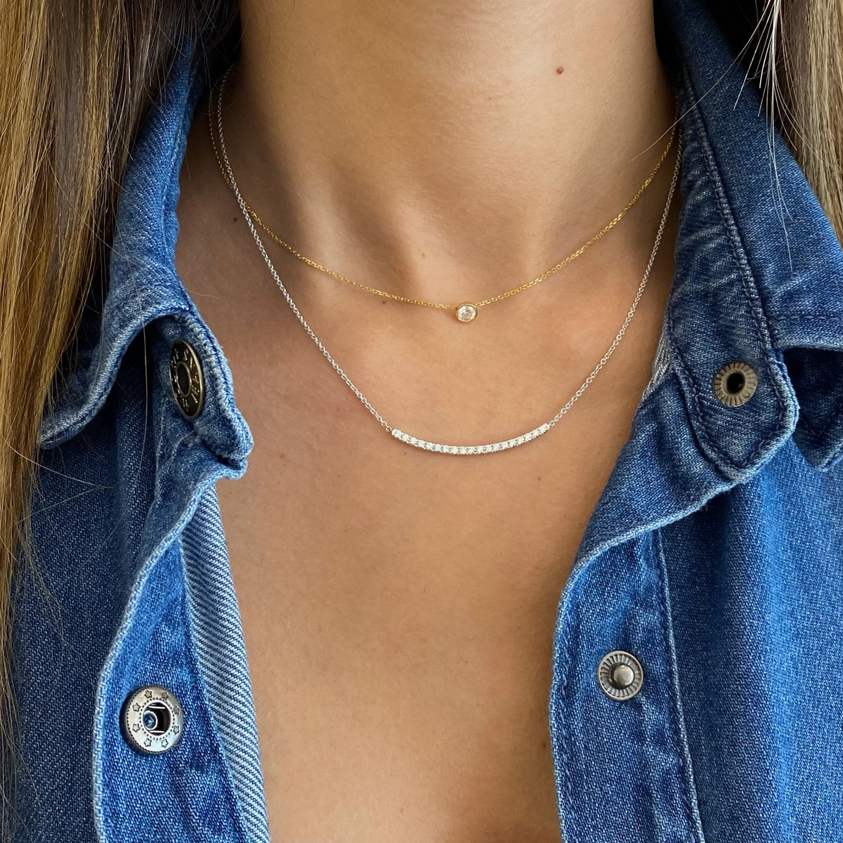 Female Model Wearing Diamond Curved Bar Necklace  - 18K gold weighing 4.12 grams  - 19 round diamonds totaling 0.40 carats