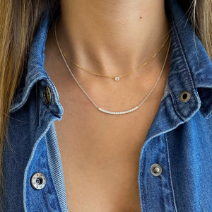 Female Model Wearing Diamond Curved Bar Necklace  - 18K gold weighing 4.12 grams  - 19 round diamonds totaling 0.40 carats