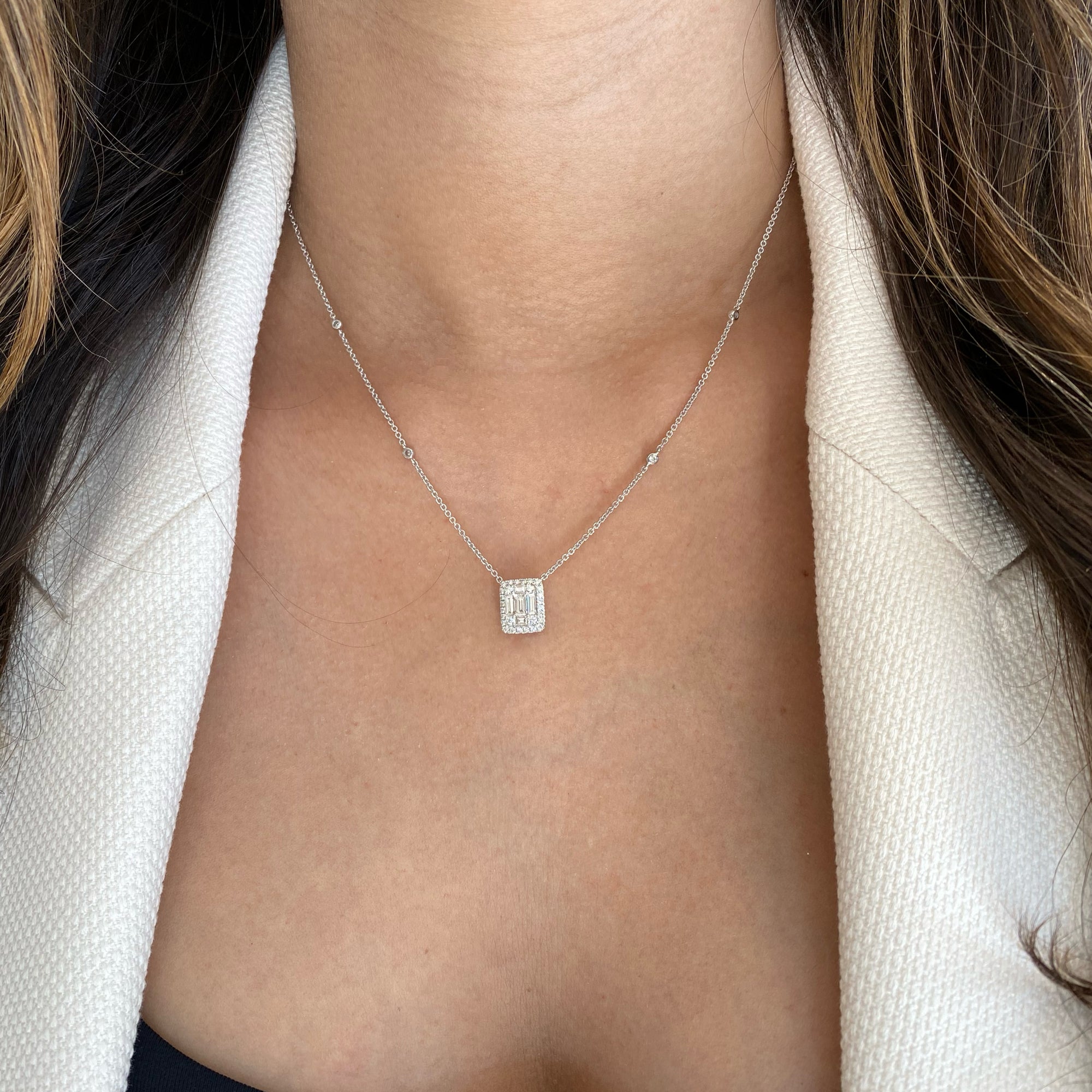 Solid 18k white gold weighing 4.22 grams with 32 round diamonds weighing 0.29 carats and 5 slim baguettes weighing 0.45 carats Emerald-Cut Diamond Illusion Pendant Necklace | Nuha Jewelers