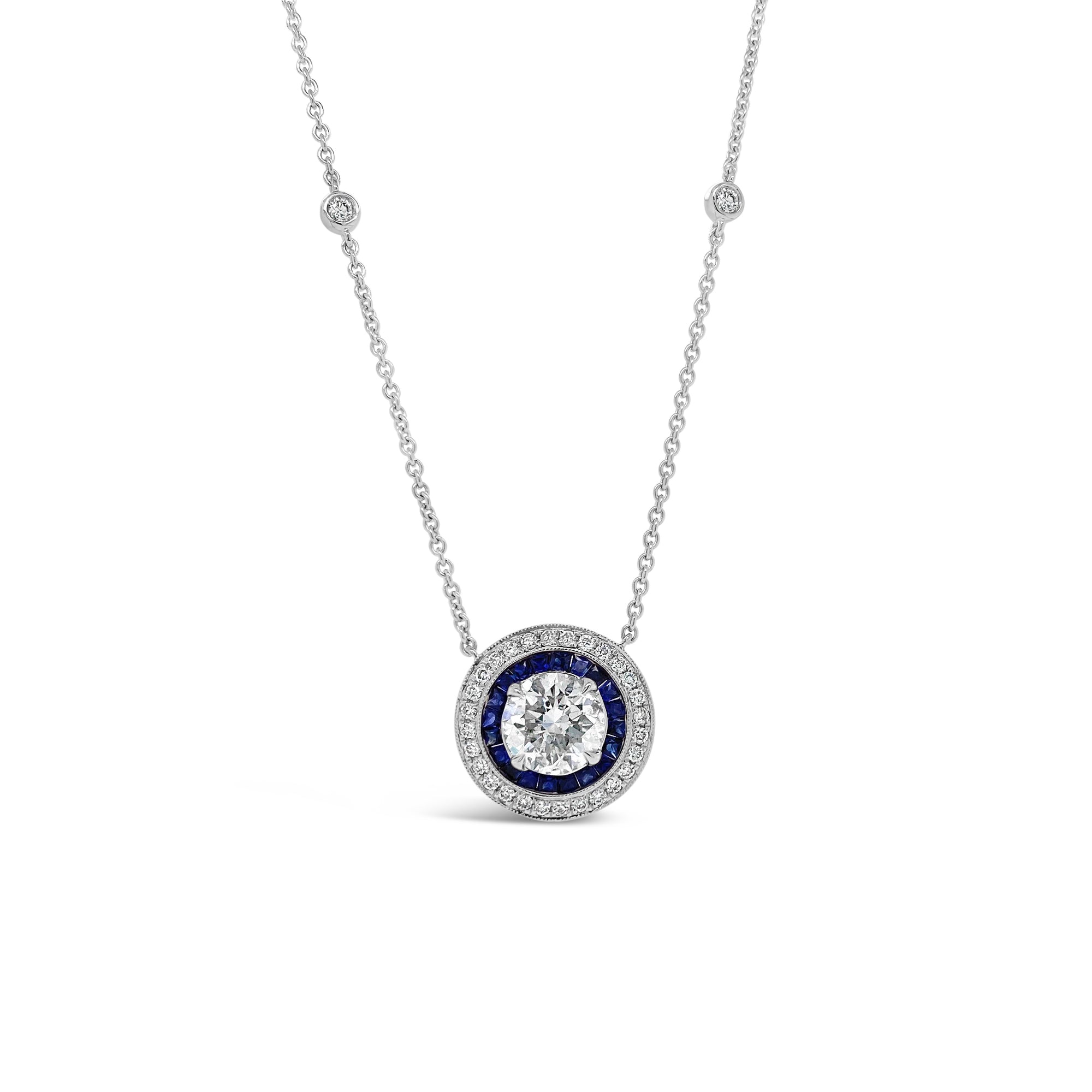 Diamond Solitaire Necklace with Sapphires and Bezel-Set Diamond Stations  - 18K gold weighing 5.50 grams  - 1.39 ct round brilliant-cut diamond (GIA-graded G-H color, I2 clarity)  - 20 sapphires totaling 0.59 carats  - 32 round diamonds totaling 0.30 carats