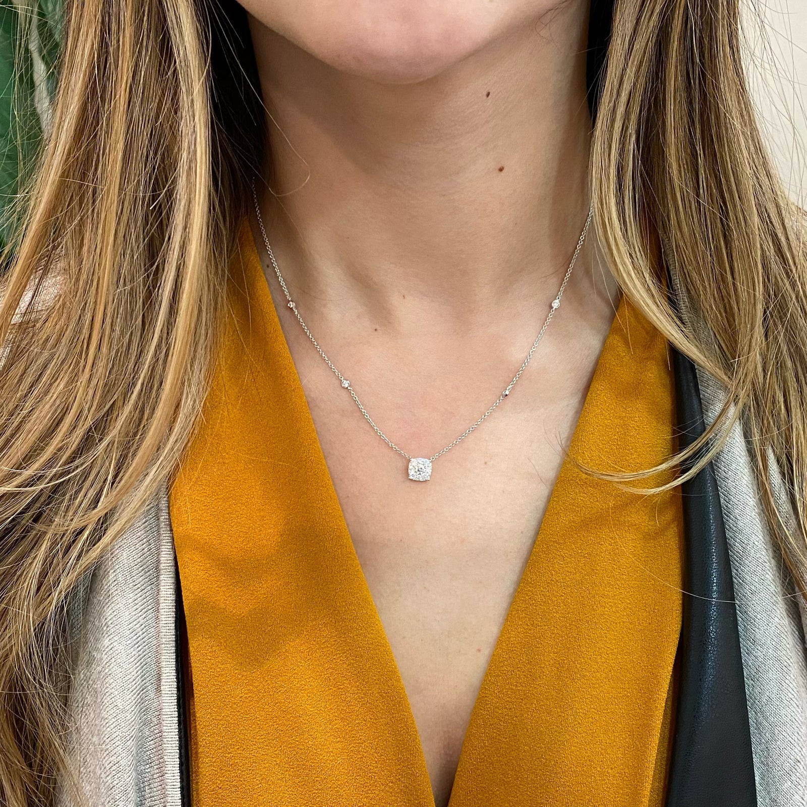 Halo Diamond Cushion Pendant with Bezel-Set Diamonds  - 18K gold weighing 4.06 grams  - 0.18 ct round diamond  - 12 round diamonds totaling 0.40 carats