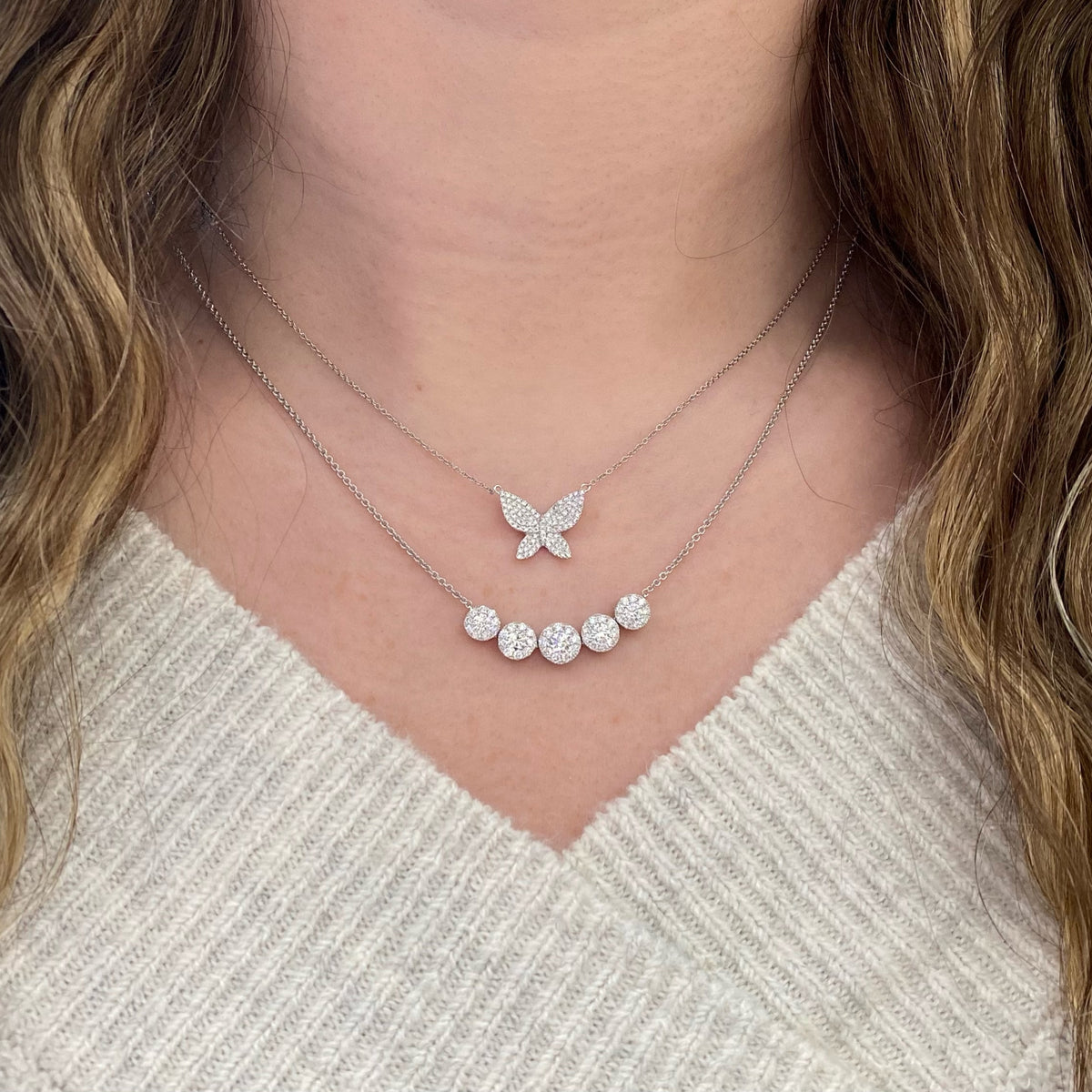 Female Model Wearing Halo Diamond Bar Necklace  - 14K gold weighing 4.39 grams  - 5 round diamonds weighing 0.56 carats  - 45 round diamonds weighing 0.53 carats