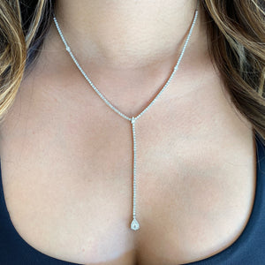 Female model wearing Diamond teardrop lariat necklace - 18K gold weighing 12.96 grams  - 167 round diamonds weighing 3.44 carats
