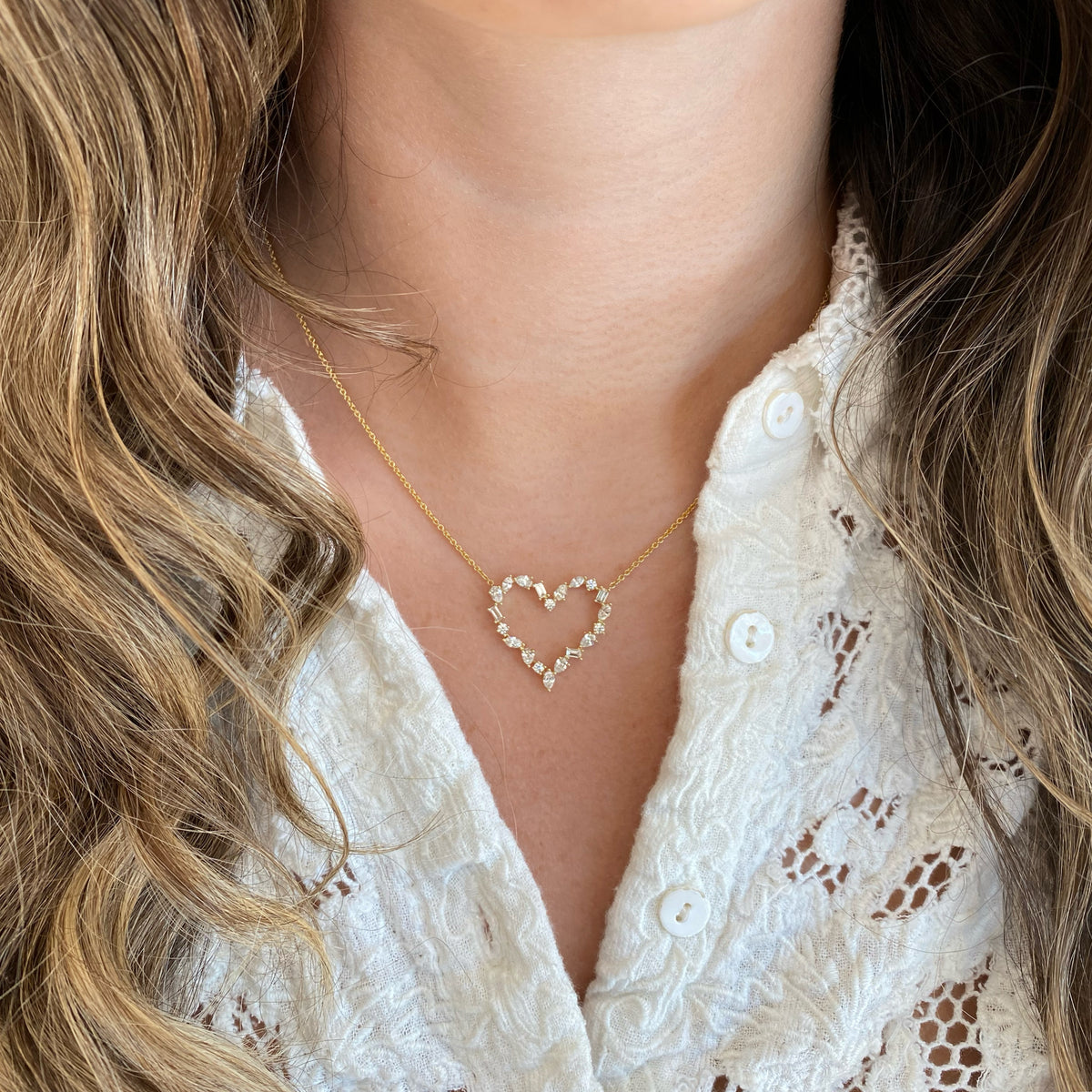 Female Model Wearing Solid 18K yellow gold weighing 4.76 grams with 20 mixed shape diamonds weighing 1.33 carats Mixed Shape Diamond Open Heart Pendant Necklace | Nuha Jewelers