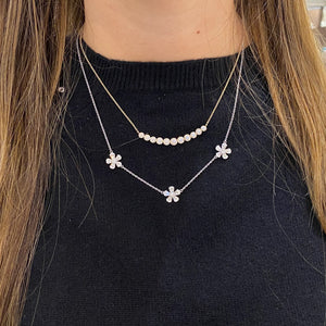 Female Model Wearing Round & Baguette Diamond Flower Station Necklace  -14K gold weighing 3.87 grams  -33 round diamonds weighing 0.43 carats  -30 slim baguettes weighing 0.71 carats