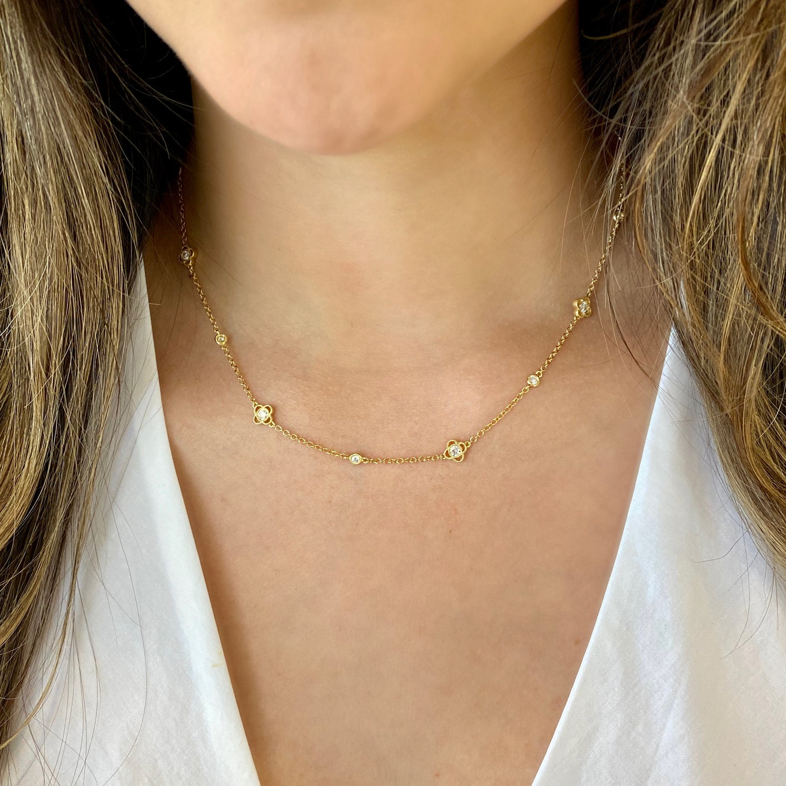 Diamonds by the Yard with Trefoils  - 14K gold weighing 5.83 grams  - 15 round diamonds totaling 0.90 carats