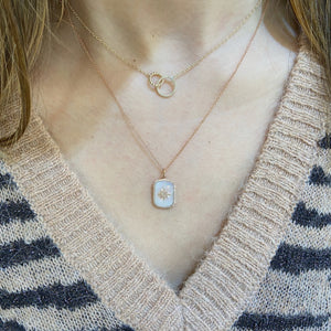 Female Model Wearing Diamond Starburst & Mother of Pearl Dog Tag Necklace  - 14K gold weighing 2.05 grams  - 59 round diamonds totaling 0.15 carats  - Mother of pearl