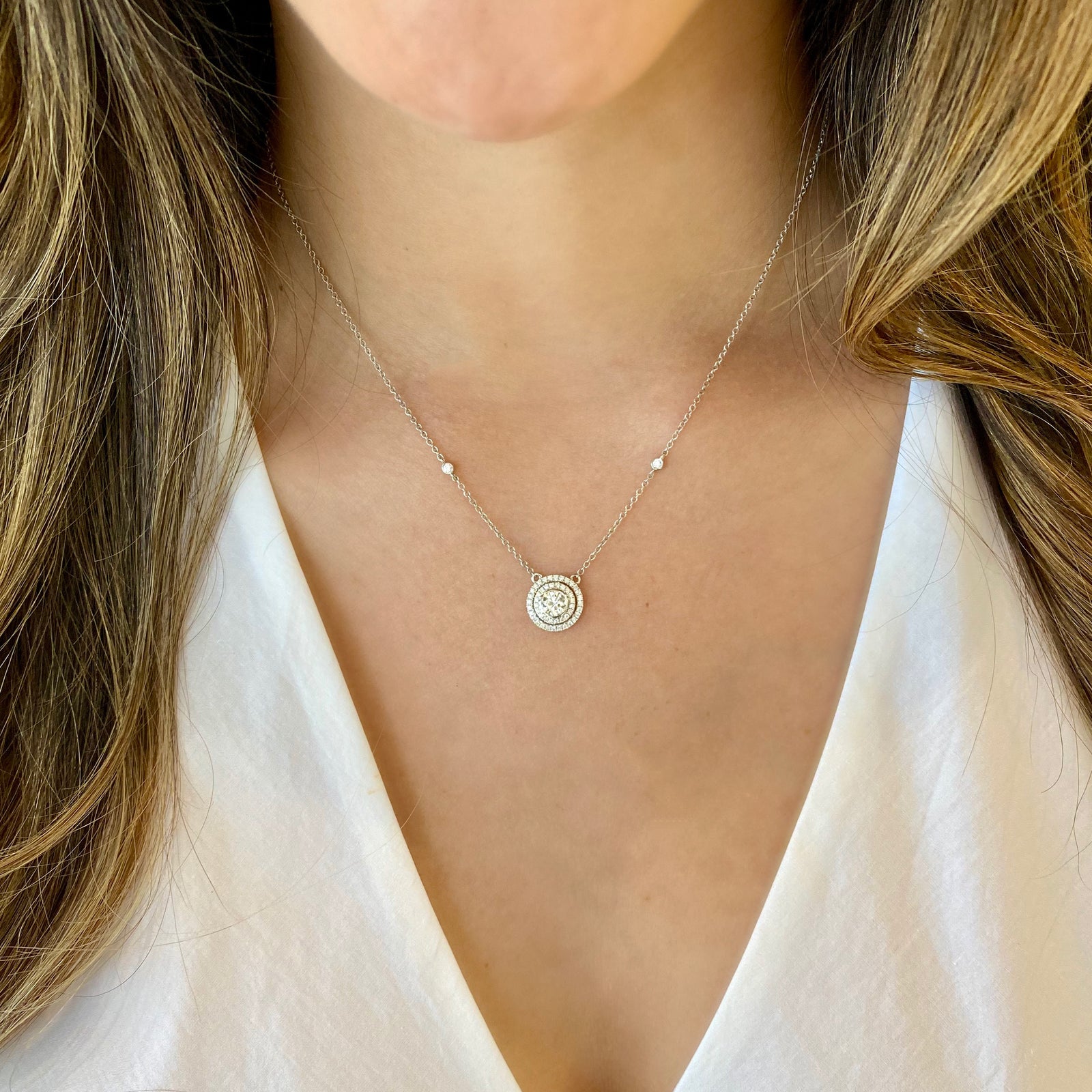 Diamond Double Halo Pendant Necklace  -18k gold weighing 3.31 grams  -50 round diamonds totaling 0.29 carats  -1 round diamonds 0.45 carats (G-color, VS1 clarity)