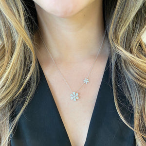 Female Model Wearing Pave Diamond Double Daisy Necklace  -14K gold weighing 3.48 grams  -146 round diamonds totaling 0.39 carats  -2 round diamonds totaling .05 carats