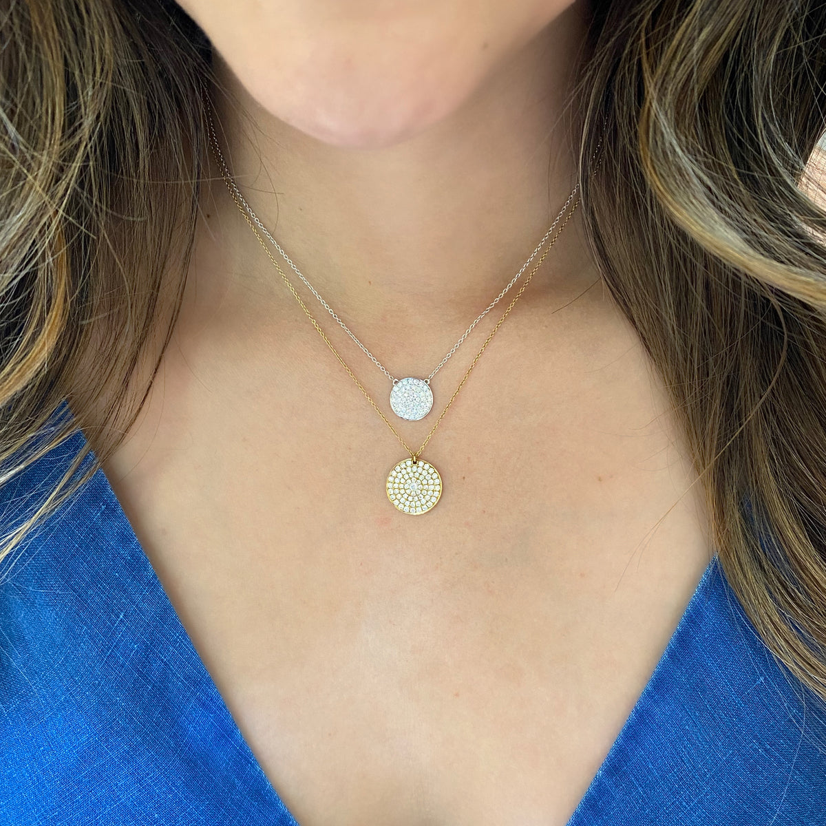 Female Model Wearing Diamond Disc Pendant Necklace  -18K gold weighing 4.21 grams  -66 round pave-set diamonds totaling 0.81 carats.