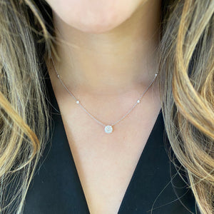Female Model Wearing Diamond Small Halo Station Necklace  -14K gold weighing 3.41 grams  -13 round shared prong-set diamonds totaling 0.34 carats  -1 round diamond 0.22 carats.