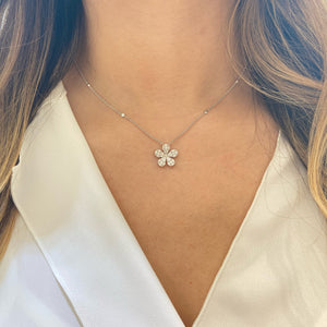 Female Model Wearing Diamond Daisy Pendant Necklace  Available in yellow, white, & rose gold.  Please allow 4-6 weeks for delivery if item is not in stock.