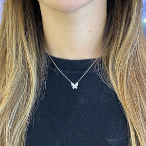 Female model wearing Diamond Butterfly Pendant Necklace -14K gold weighing 2.20 grams -70 round pave set diamonds totaling 0.20 carats